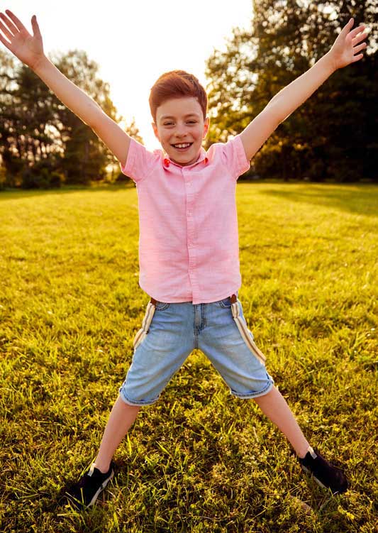 delighted-boy-standing-with-outstretched-arms-cropped