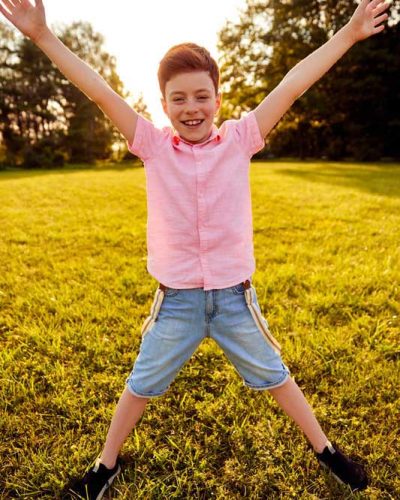 delighted-boy-standing-with-outstretched-arms-cropped
